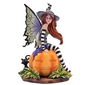 A resin statue of a fairy sitting on a pumpkin. Home desktop decoration,