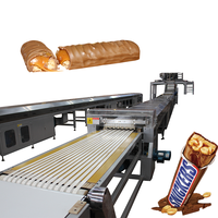 Volledig automatische productielijn voor ontbijtgranen, granola, eiwitrepen en Snickers-achtige producten, inclusief spreiden, koelen, snijden, omhullen en PLC-gestuurde TGMachine.