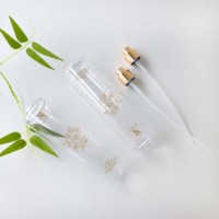 Échantillon et bouteille transparente en plastique de 250ml de forme ronde de style luxueux avec pulvérisateur doré pour cosmétiques