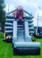 Château gonflable dinosaure 2026 avec toboggans aquatiques pour jardin, à vendre