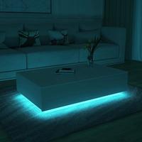 Table basse centrale simple à finition brillante avec 4 tiroirs et lumière LED pour le salon