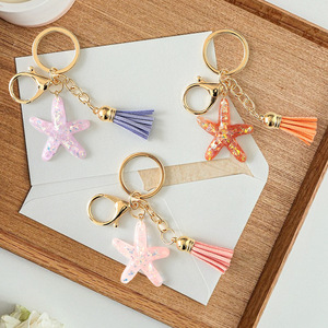 Porte-clés Étoile de mer en cristal avec pendentif pompon, impression UV couleur intégrale, pour sacs d'école et accessoires de clés pour femmes - Product Image 1