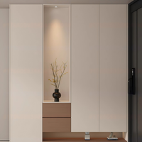 Meuble à chaussures minimaliste couleur claire sur mesure avec grands tiroirs pour l'entrée d'un appartement de jeune couple, pour chaussures et semelles intérieures