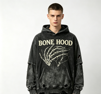 Hoodie Oversize Kornit DTG, imprimé vintage avec motif main squelette et lettres audacieuses, à plusieurs déchirures, bords bruts et coupe délavée