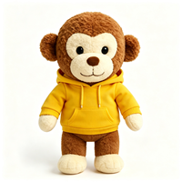 Peluche singe marron vêtu d'un sweat à capuche jaune vif, animal en peluche décontracté de dessin animé, adorable peluche singe
