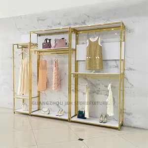 Espositore per negozio di abbigliamento donna di moda design con logo personalizzato in metallo dorato con mensole appese per vestiti