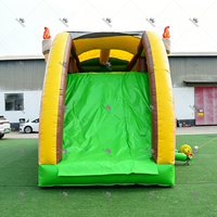 Château gonflable commercial T-Rex Dinosaure avec toboggan et zone de saut, pour événements extérieurs et location pour fêtes d'enfants