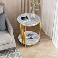 Table d'appoint ronde en pierre frittée avec structure en métal doré