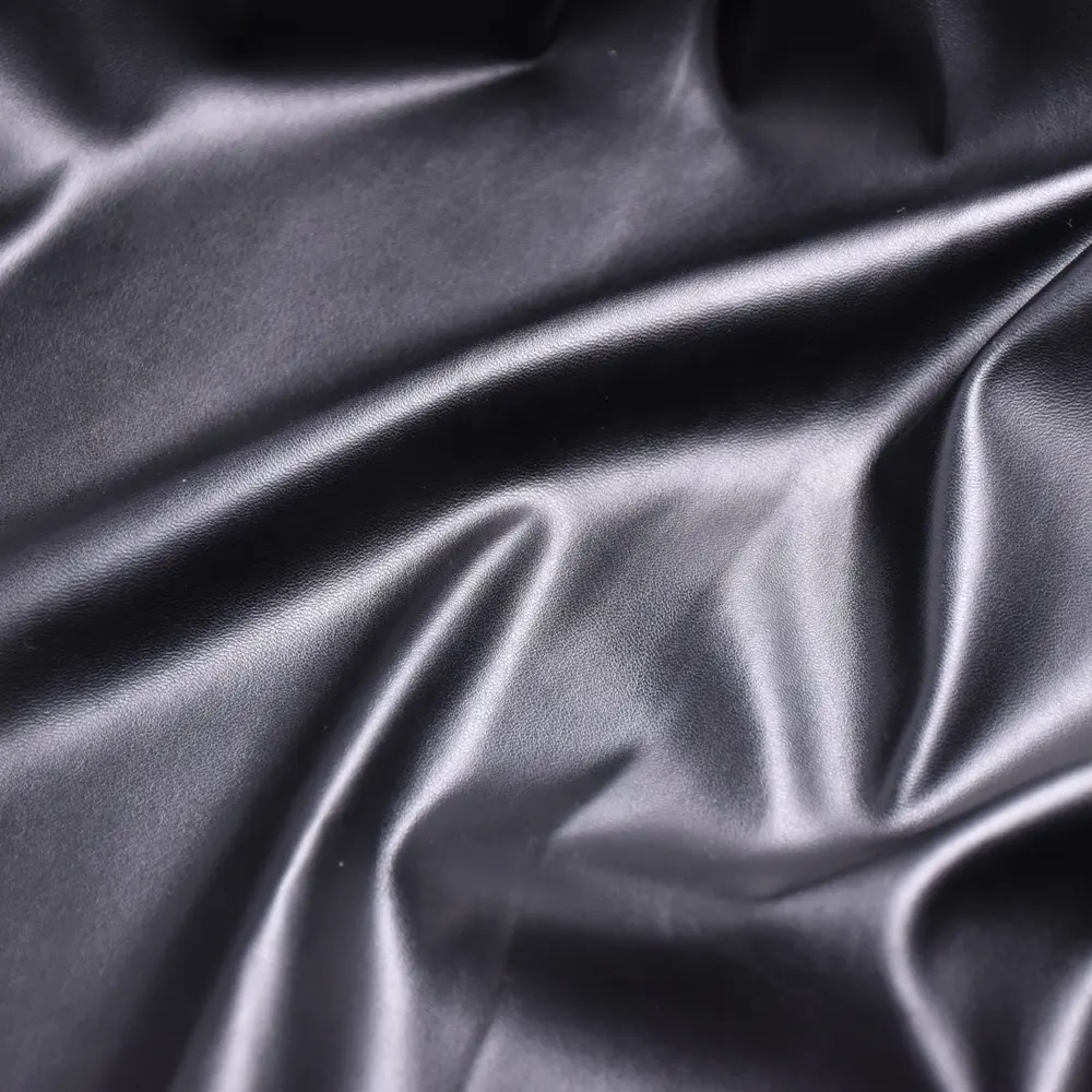 Prendas de vestir de cuero artificial baratas tela de cuero sintético ropa telas de cuero Pu para prendas/Pantalones