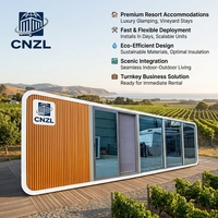 Cabane préfabriquée moderne CNZL blanche et noire avec façade entièrement vitrée, unité modulaire portable pour maison d'hôtes de station balnéaire