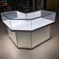 Comptoir de présentation de bijoux de luxe en forme de L, cadre or rose, base miroir, éclairage LED pour salles d'exposition de montres haut de gamme et magasins de détail