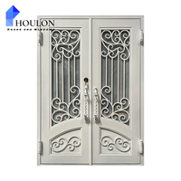Porte d'entrée double moderne en fer forgé blanc avec décorations festonnées et verre trempé transparent pour villa