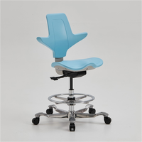 Protecteur orthopédique de colonne vertébrale de selle Chaise d'équitation ergonomique Tabouret de selle d'équitation de dentiste Chaise pivotante roulante Chaises moussantes en PU