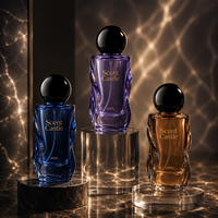 Flacon de parfum rond de luxe de 40 ml, nouveau design, emballage en verre avec pompe à pression et bouchon rond.
