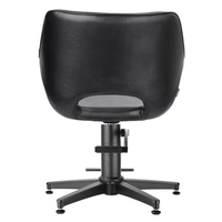 Fauteuil de coiffure moderne en similicuir noir ajouré, réglable en hauteur par vérin hydraulique et pivotant à 360°