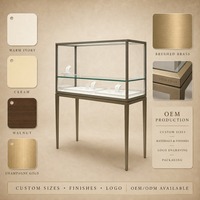 Vitrine d'îlot pour bijoux sur mesure, en verre trempé, avec éclairage LED et métal brossé, pour aménagements de magasins de détail