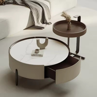 Table basse ronde en cuir crème pour petit appartement, avec plateau en pierre, et petite armoire de rangement latérale pour salon