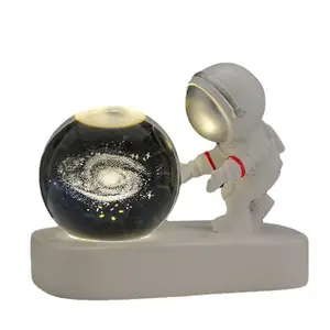 Creative astronaut strolling in the starry sky, small night light with carved crystal ball, luminous base decoration