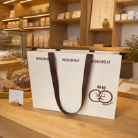 Sacs en papier mat laminé personnalisés avec poignées en ruban et impression de logo, vente en gros pour les magasins de vêtements