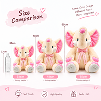 Peluche personnalisée en forme d'éléphant crème avec oreilles roses et nœud en ruban, idéale pour la chambre de bébé, cadeau ou fourniture pour boutique.