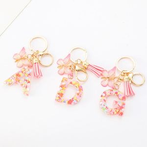Porte-clés initial en résine 26 lettres avec pendentif papillon et pompon, accessoire élégant pour sac à main femme - Product Image 1