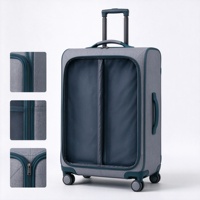 Valise à roulettes souple grise et turquoise avec compartiment avant zippé, deux poches en filet et poignée télescopique