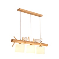 Lustre moderne japonais simple à LED Lampe de salle à manger en bois massif sur le thème des oiseaux pour table à manger à trois têtes à usage domestique
