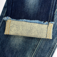Tissu denim brut à faible rétrécissement (3 %), forme stable, texture slub non lavée, mélange coton-polyester, denim rigide