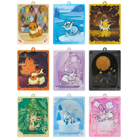 Set de 17.5 insignias de evolución de Pokémon Eevee y caja de regalo con colgante de exhibición de tarjetas de arena movediza