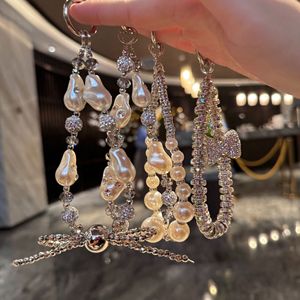 พวงกุญแจโบว์คริสตัลวิบวับหรูหรา ประดับมุก พร้อมสายคล้องข้อมือสั้นแบบมีคลิปหนีบ สำหรับตกแต่งเคสมือถือ - Product Image 2
