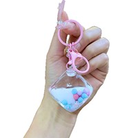 Nouveau porte-clés pendentif de sac en acrylique, rempli d'huile et de sable, avec clochette, motif dessin animé