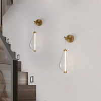 Applique murale LED minimaliste italienne en verre ambré fumé transparent en forme de goutte d'eau, base dorée, lumière chaude, pour villa et fond TV