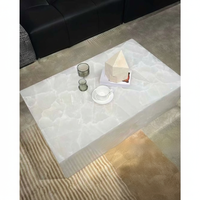Table basse de salon moderne de luxe en marbre naturel blanc translucide, table à manger îlot, mur de fond