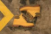 Bottes de sécurité en cuir véritable imperméables pour la mode, avec embout en acier, à lacets, semelle extérieure en caoutchouc et doublure en maille