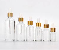 Vente en gros de flacons compte-gouttes en verre pour huiles essentielles de 5 ml à 100 ml avec couvercle en bambou, compte-gouttes doré, impression sérigraphique, couleur personnalisée