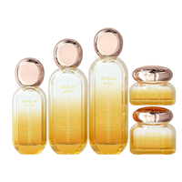 Ensemble de produits de soin de la peau haut de gamme, flacon en verre ovale 30 ml 50 ml, flacon d'essence avec tête de pompe 30 g 50 g, pot à crème avec couvercle doré