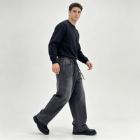 Jean élastique à taille élastique pour homme, en denim noir délavé, coupe ample à jambe large, avec cordon de serrage et ourlet retroussé sur les côtés, idéal pour le streetwear