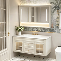 Ensemble de meubles de salle de bain de style français de luxe, armoire flottante blanche crème avec porte en verre cintrée et miroir LED intelligent, OEM ODM