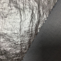 Tissu tissé froissé en nylon 100% pour femmes à la mode classique avec revêtement en polyuréthane de transfert imperméable à la sensation de peau brillante pour une utilisation dans un sac