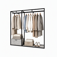 Présentoir à vêtements certifié ETL, en acier inoxydable noir, courbé, autoportant, avec table de présentation pour boutique