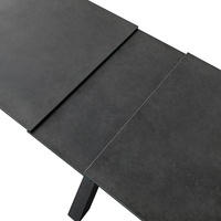 Table à manger en céramique de couleur béton avec deux panneaux coulissants extensibles et pieds croisés peints en poudre noire italienne