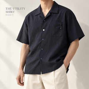 Camisa de hombre de manga corta con cuello campamento, corte holgado, color liso, con botones, informal, de verano, con bolsillo en el pecho, venta al por mayor personalizada - Product Image 1