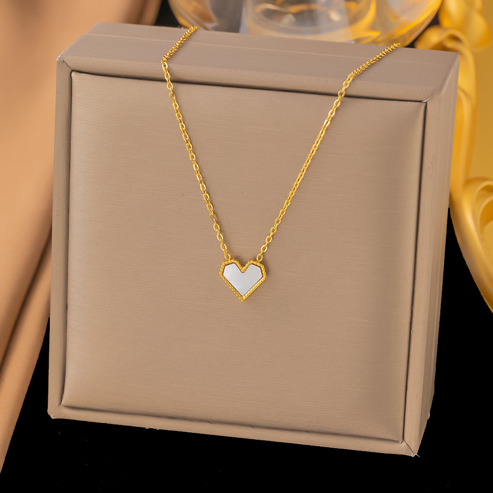 White shell-shaped heart pendant on stainless steel necklace