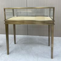 Vitrine de présentation de bijoux de luxe, en acier inoxydable, cadre plaqué titane, verre trempé transparent pour centre commercial