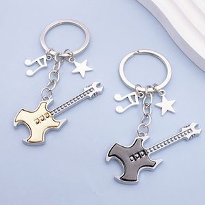 Nuevo llavero de guitarra musical de dos tonos con colgante de pentagrama para bolsos y llaves de coche - Product Image 1