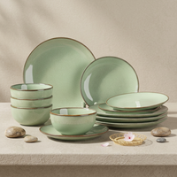 Collection de vaisselle en poterie verte rustique élégante EKA, assiettes et bols en céramique au look artisanal avec bord infusé de fer