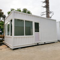 Maison préfabriquée à ossature en acier blanc avec panneaux muraux entièrement vitrés et porte à charnières, prête à l'emploi pour usine, entrepôt ou livraison rapide.