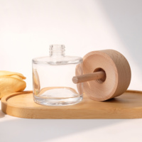 Flacon d'huile parfumée en verre transparent rond avec couvercle en bois pour l'aromathérapie