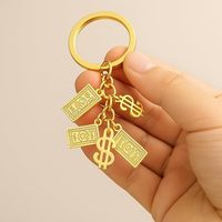 Porte-clés multi-breloques en or noble avec signe dollar et breloque sac de richesse pour les amateurs d'argent