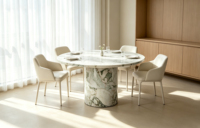 Table à manger élégante et minimaliste en marbre Arabescato à plateau rond et piétement unique, idéale pour les maisons modernes à plan ouvert